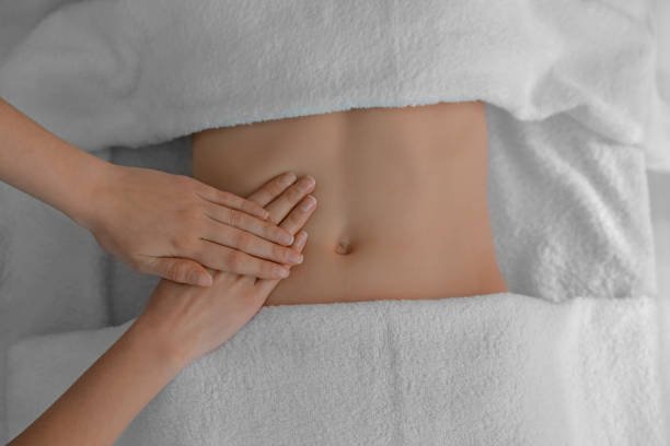 woman receiving professional belly massage, closeup view